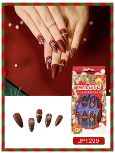 Macro detail of Christmas press-on nails with matte brown finish, snowflakes and rhinestones