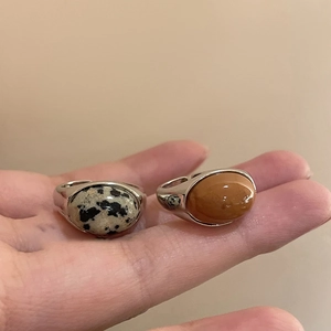 Detail view of retro open rings with oval spotted stone and brown gemstone inlays