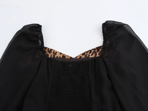 Détail d'une robe à encolure carrée, imprimé léopard, corsage froncé et manches bouffantes