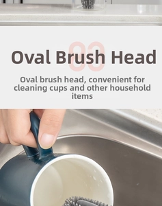 Detail of the oval silicone brush head cleaning a deep blue ceramic mug effectively