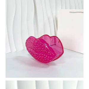 Pink lip-shaped hair claw clip in open position on a clean white surface
