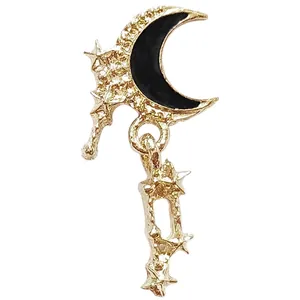 Golden crescent moon and star alloy nail charm with black enamel and hollow design