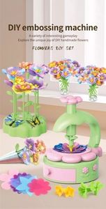 Close-up of DIY embossing machine set with floral petals and colorful craft accessories