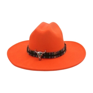 Close-up of vibrant orange felt cowboy hat featuring an ethnic band and silver bull head
