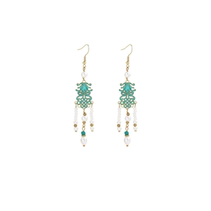 Detail of butterfly pearl tassel earrings with green hollow knots in vintage style