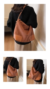 Detail of vintage brown suede tote bag with leather patchwork corners and thin straps