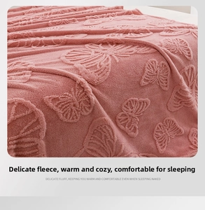 Close-up of pink flannel blanket with 3D embossed butterfly patterns and soft plush texture