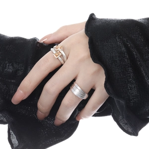 Double-layer hollow diamond ring and yellow gemstone silver band on model hand