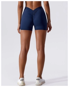 Detailed back view of high-waist scrunch yoga shorts in deep blue seamless stretch fabric