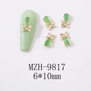 Detail view of 6x10mm cat-eye stone butterfly nail art charms with golden alloy base
