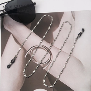 Detail of silver stainless steel glasses chain with non-slip loops on fashion magazine