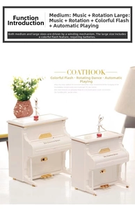 Detail view of white piano music box with rotating ballerina and gold trim ornament
