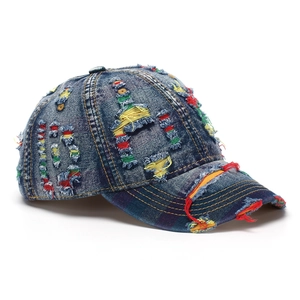 Close-up of distressed denim baseball cap with colorful stitching and plaid brim detail