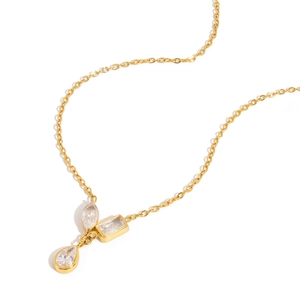 Macro detail of 18K gold necklace with teardrop, marquise and emerald cut zircon stones