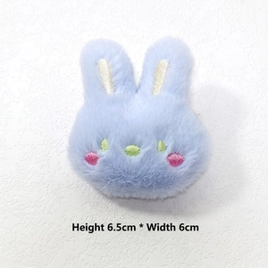 Detail view of light blue plush bunny accessory with embroidery, 6.5cm x 6cm size