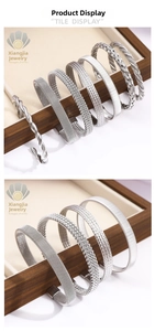 Detailed view of silver braided cuff bracelets with diverse woven and textured patterns