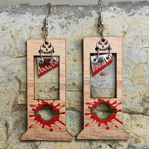 Halloween guillotine wooden drop earrings with red blood splatter on stone background