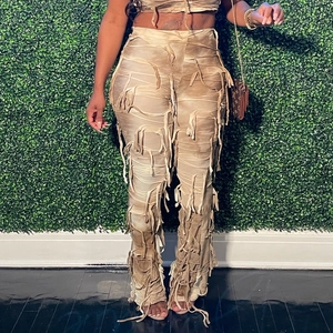 Dettagli del crop top in maglia kaki e pantaloni svasati con design a bende e nappe