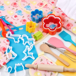 Kids baking set with pink apron, chef hat, rolling pin and assorted animal cookie cutters