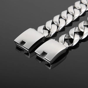 Polished silver stainless steel Cuban link chain for men with square clasp on black surface