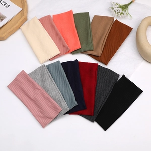 Cross-knot knitted headbands in thirteen solid colors with a vertical ribbed texture