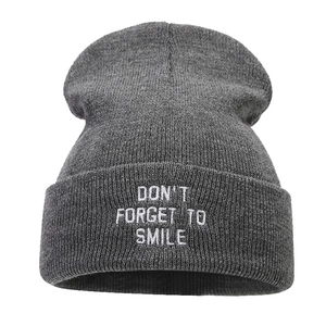 Gray knitted beanie with white embroidery text 'DON'T FORGET TO SMILE' for winter warmth
