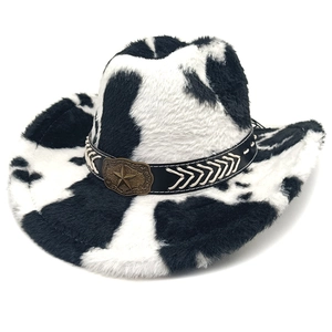 Detail of cow print cowboy hat with plush texture and bronze star metal emblem