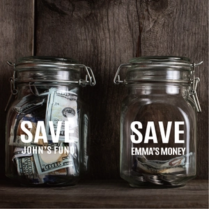 Detail view of two personalized savings glass jars with metal lids and custom lettering