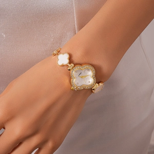 Close-up of four-leaf clover quartz watch with diamond bezel and mother of pearl dial