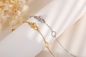 Detailed view of elegant interlocking double rings in gold and silver with cubic zirconia