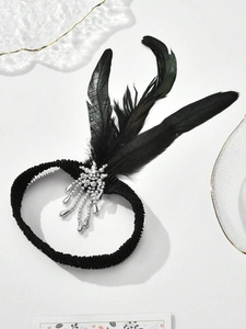 Detail of 1920s vintage black feather headband with silver beaded tassel decoration