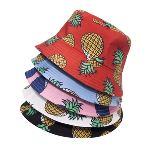 Stack of colorful pineapple print bucket hats in red, blue, pink, white and black