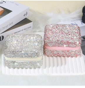 Elegant rhinestone jewelry organizer boxes in silver and pink with zipper closure detail