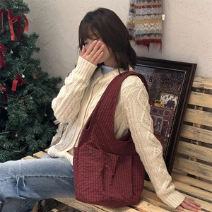 Detail of red checkered tote bag with front pocket in a cozy warm holiday setting