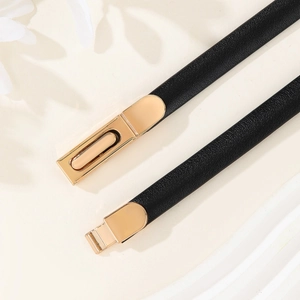 Elegant black patent leather skinny belt for women with a gold buckle for dresses