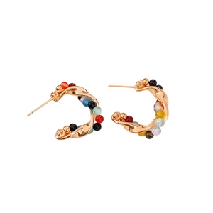 Vintage geometric golden twist earrings with colorful agate beads on white background