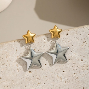 Two-tone stainless steel star drop earrings in gold and silver finish on stone