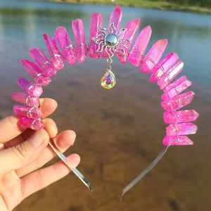 Detail of pink crystal wizard crown with sun charm and teardrop pendant on silver headband