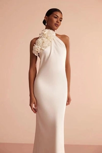 Détail de la décoration florale 3D sur l'épaule de la robe de soirée en satin blanc