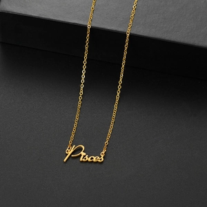 Detailed macro shot of golden Pisces zodiac pendant on a delicate chain necklace