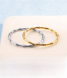 Detail of polished bamboo joint stainless steel bracelets in gold and silver finish