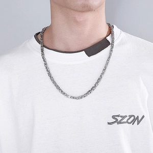 Silver Byzantine chain necklace for men in stainless steel displayed on a model