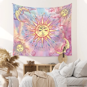 Detail of bohemian sun and moon tapestry hanging on a bedroom wall with cozy home decor