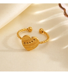 Macro shot of 18K gold plated heart ring featuring twisted rope band and engraved textures