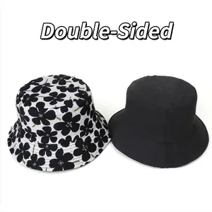 Reversible cotton bucket hat with floral print and solid black side for sun protection