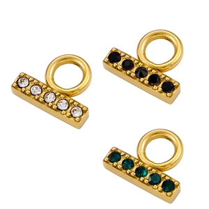 Close-up of T-bar jewelry connectors with gold plating and colorful inlaid crystals