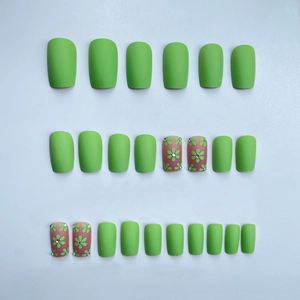 Green and floral matte press-on nail set with rhinestones on a clean white background