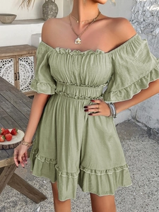 Detail of ruffle sleeves and off-shoulder neckline on a green summer mini dress