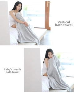 Detailed texture of light grey bamboo charcoal fiber bath towel with vertical stripes