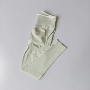 Detail of high waist mint green seamless yoga pants showing elastic ribbed waistband